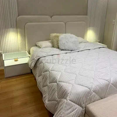 Queen upholstered bed with padded headboard and nightstands - cream