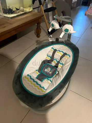 Gently used baby bouncer with straps and toy mobile