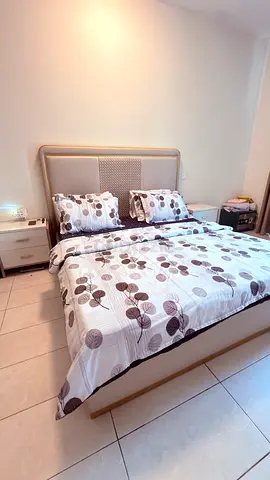 King size bed with upholstered headboard and two bedside tables and dressing table