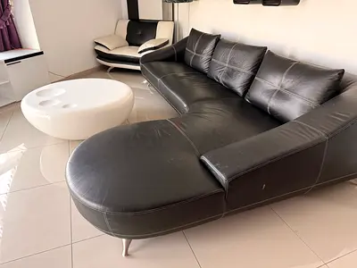 Black leather curved sectional sofa with chaise