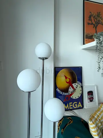 Three-globe floor lamp with white glass shades and chrome finish