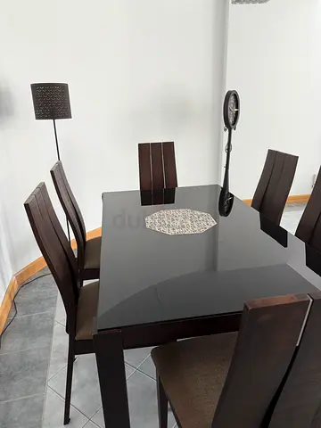 Dark wood dining table with 6 matching chairs