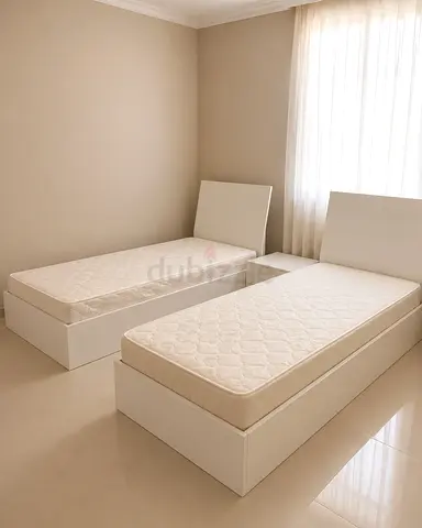 Pair of Single White Beds with Mattresses and Nightstand