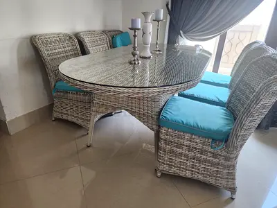 5-piece Wicker Dining Set with Glass Top and Blue Cushions. Outdoor