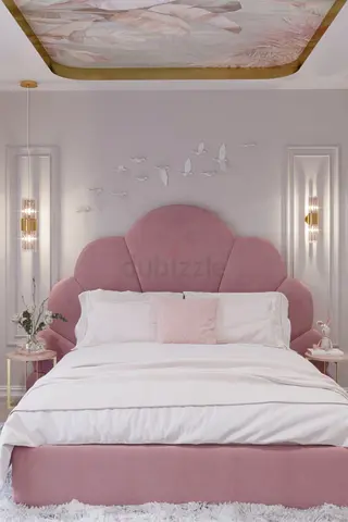 Pink upholstered queen bed with scalloped headboard