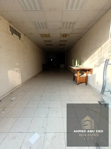 Commercial shop for annual rent in Al Rashidiya 1, Ajman, offering 1,500 sq ft including mezzanine, located on a busy main road near Al Pearl Towers,