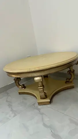 Round vintage-style wooden coffee table with carved base