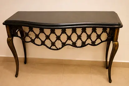Black Marble console table with lattice-skirt base in vintage gold, and mirror optional