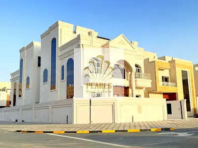 Luxury corner villa for annual rent in Al Helio 2 Ajman. 5BR, hall & majlis, 7 baths, maid room, ce
