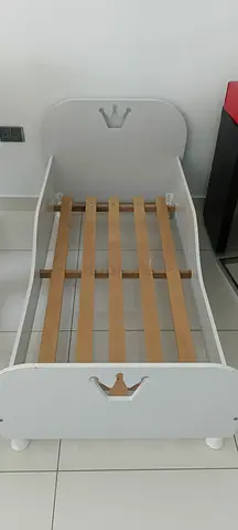 2 White wooden toddler beds with crown design - good condition. Mattresses included.