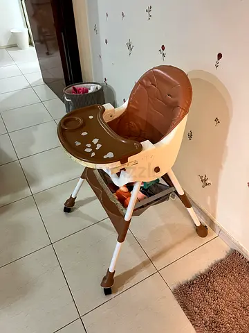 Used baby high chair with removable tray — brown/cream, with wheels, good condition