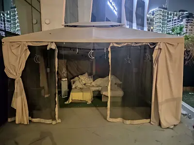 Outdoor gazebo with mosquito netting and curtains - excellent condition. Retail price 2000