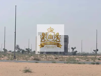 Commercial land in Al Rahmaniya project, behind Sharjah International Airport, freehold for Arabs, ready for immediate construction.