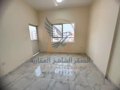 First occupancy apartment for annual rent in Al-Aliya, two rooms and a hall, two bathrooms with a balcony, close to Nesto, prime location and close to