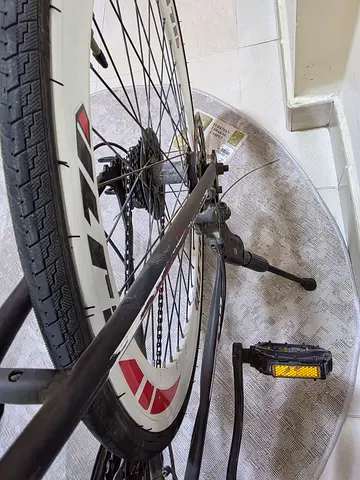 Used mountain bike wheel with rear cassette and pedal - needs minor repair