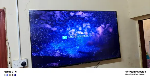 Smart 55-inch LED TV mounted on wall - good condition