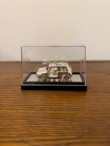 Die-cast silver classic car model in display case