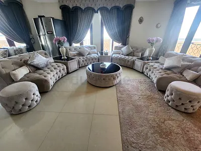 Large Curved Tufted Velvet Sofa Set with Ottoman and Coffee Table, all for 3500 aed.