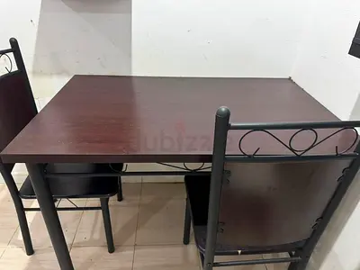 Dark wood dining table with 2 metal-frame chairs - sturdy, good condition