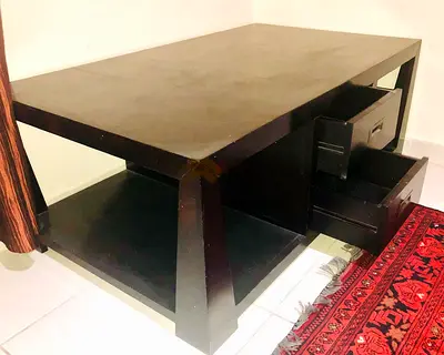 Solid dark wooden coffee table with storage drawers