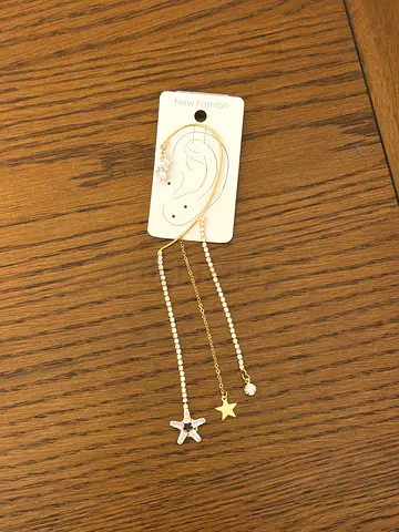 Pair of mismatched long drop star and pearl earrings (gold-tone)