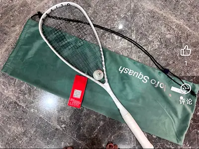 Used squash racket with cover — good condition
