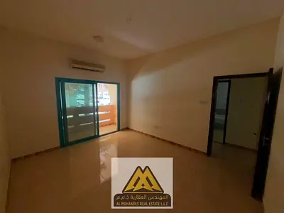 Annual rental 2-bedroom apartment in Al Nakhil, Ajman. Ground floor, balcony, split AC, one bathroom, free maintenance, near Ajman Corniche and Bahi P