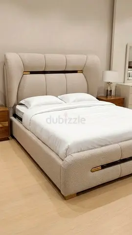 Cream upholstered king-size bed with padded headboard and storage base
