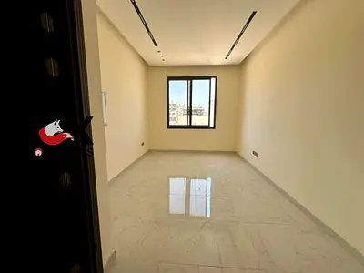 Annual rental: 1-bedroom apartment with a living room in a new building in Al Jurf 3. Features a master bedroom and 2 bathrooms. Includes one month fr