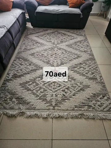 Grey geometric patterned rug, good condition - 70 AED