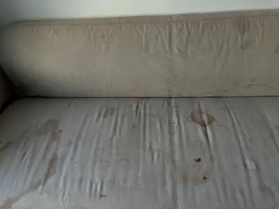 Beige 3-seater sofa with visible stains - needs cleaning or reupholstery
