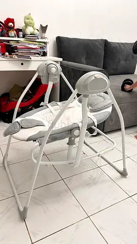 Gently used electric baby swing/rocker with cushioned seat and toy bar