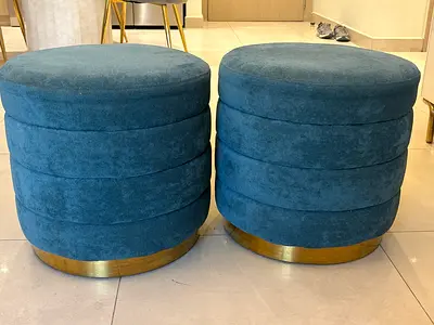 Pair of round teal velvet ottomans with gold base and wheels (moveable chairs)