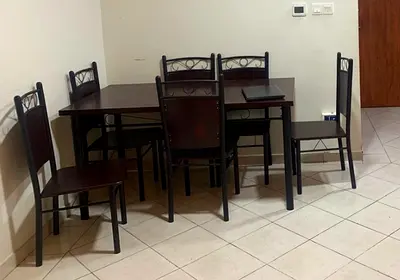 Dark wood 6-seater dining table with chairs - good condition
