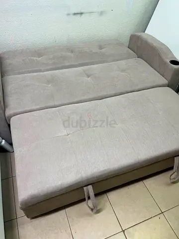 Light grey fabric sofa bed with storage and cup holder - good condition