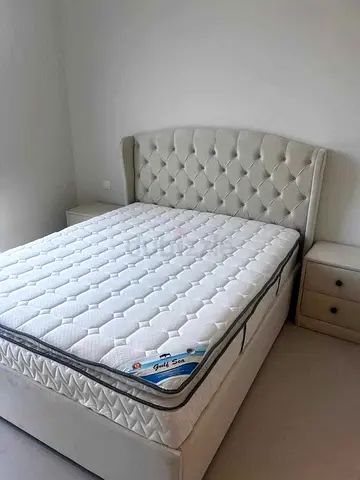 Queen upholstered bed frame with mattress and bedside tables - light beige