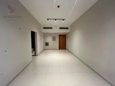 Two bedrooms and a living room for annual rent in a new and upscale building with a gym inside Al Rashidiya 1, directly on Khalifa Street, in a prime