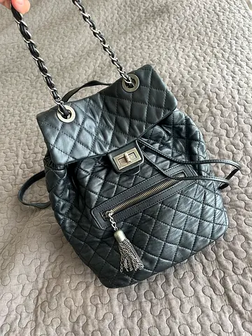 Black quilted real leather, chain-strap backpack with tassel pocket