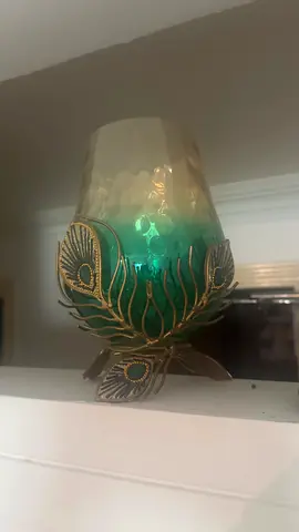 Decorative peacock feather glass candle holder with metal base