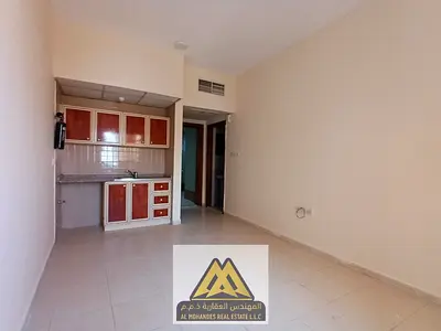 Annual studio for rent in Al Nuaimiya 2, Ajman. Central AC, AED 18,000, 4 payments, easy access to