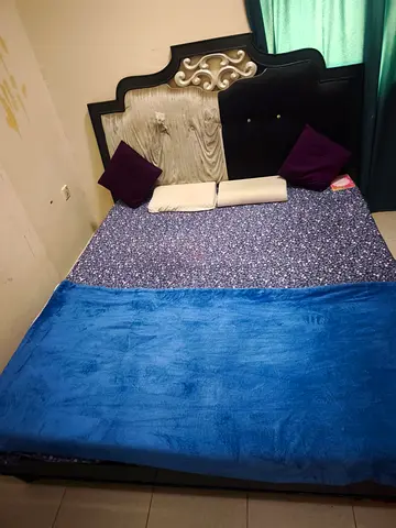 King-size bed with decorative headboard - good condition