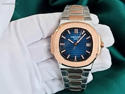 This Patek Philippe Nautilus watch features a two-tone rose gold and steel case with a blue horizont