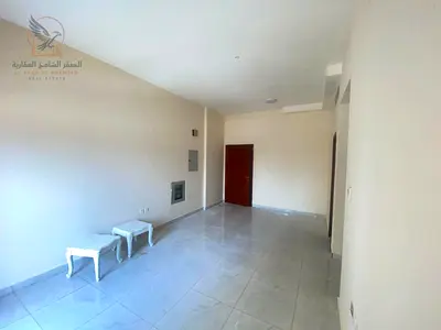 For annual rent in Al Rashidiya 2 Ajman a two-bedroom apartment with a living room two bathrooms a balcony with an open view central air conditioning