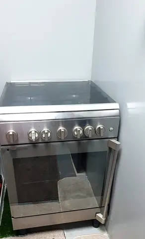 Bompani brand cooking range in good working condition. Features 4 gas burners, electric oven grill.