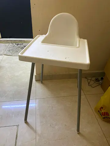 Simple white plastic baby high chair with removable tray