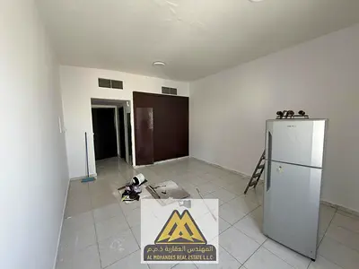 Studio for annual rent in Al Rashidiya 3, Ajman. Large space, semi-separate kitchen, central AC, built-in wardrobes, maintenance by owner. Close to al