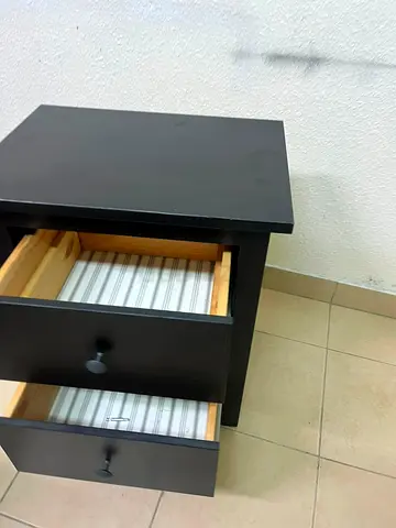 Simple black wooden bedside table with two drawers