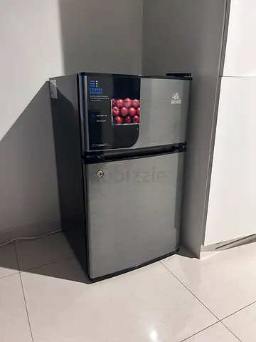 Compact silver double-door mini fridge with freezer compartment