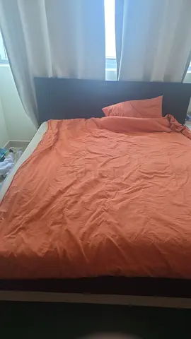 Queen bed frame with mattress and orange bedding - good condition