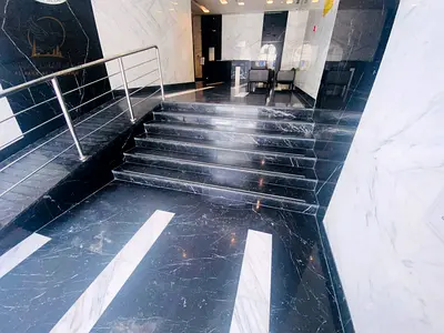 For annual rent in Ajman Al Nuaimiya a two bedroom apartment with a living room three bathrooms and a balcony with an open view Modern finishing ready
